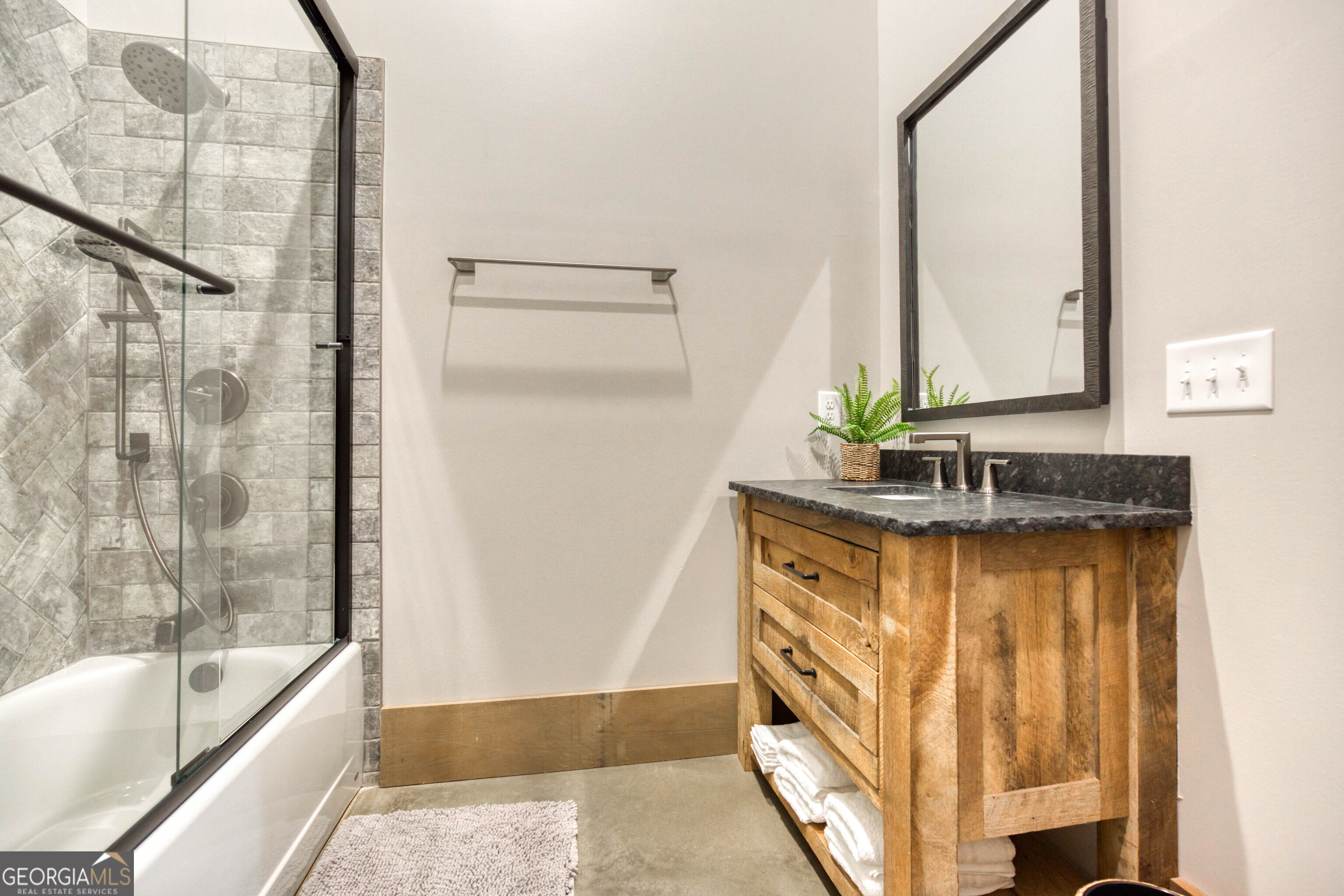 1968 Bobby Brown State Park Road Elberton, GA 30635 - Photo 49 of 97 a bathroom with a granite countertop sink and a bathtub