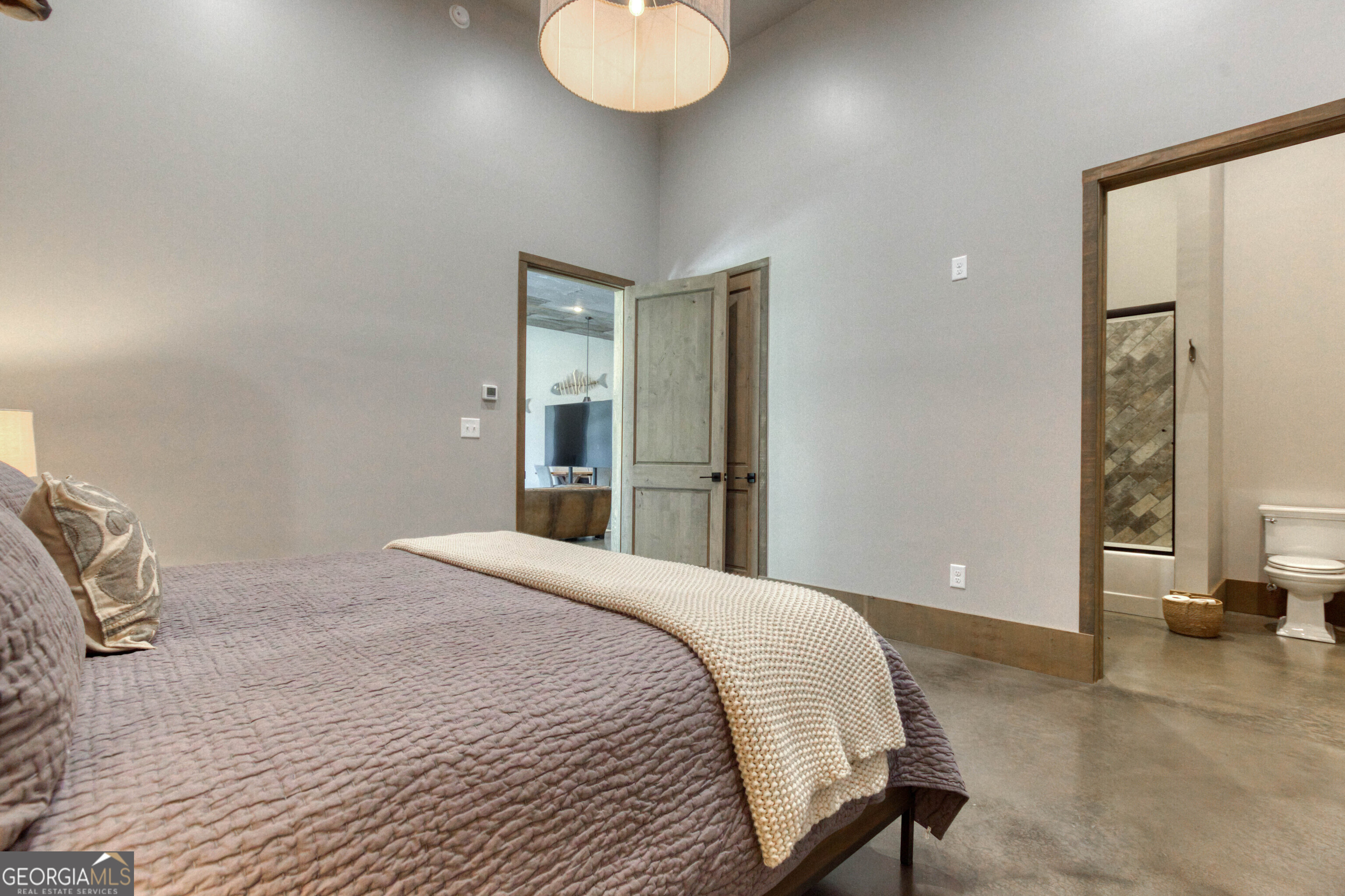 1968 Bobby Brown State Park Road Elberton, GA 30635 - Photo 51 of 97 a bedroom with a bed and a chandelier