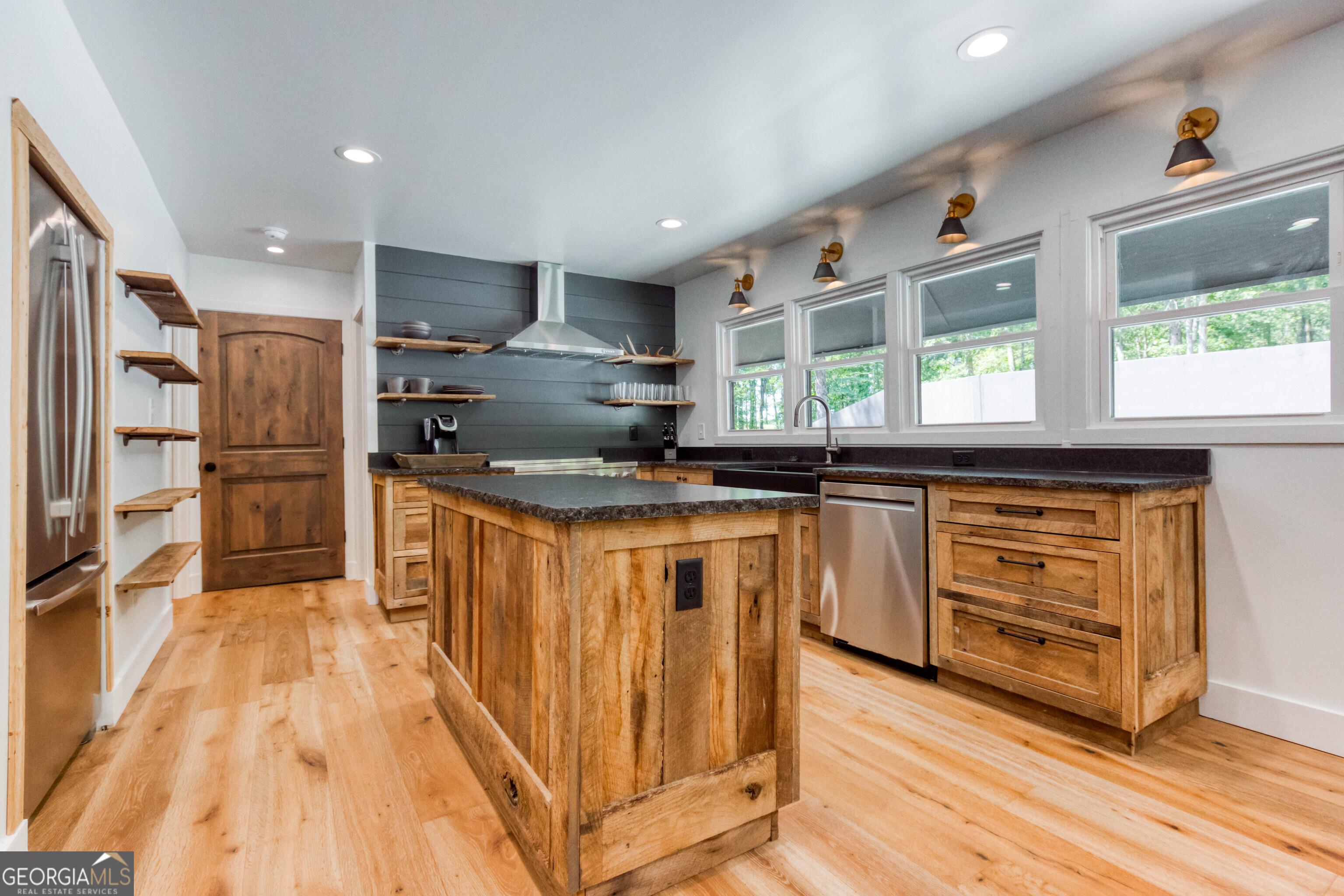 1968 Bobby Brown State Park Road Elberton, GA 30635 - Photo 82 of 97 a kitchen with stainless steel appliances kitchen island granite countertop a stove a sink and a refrigerator