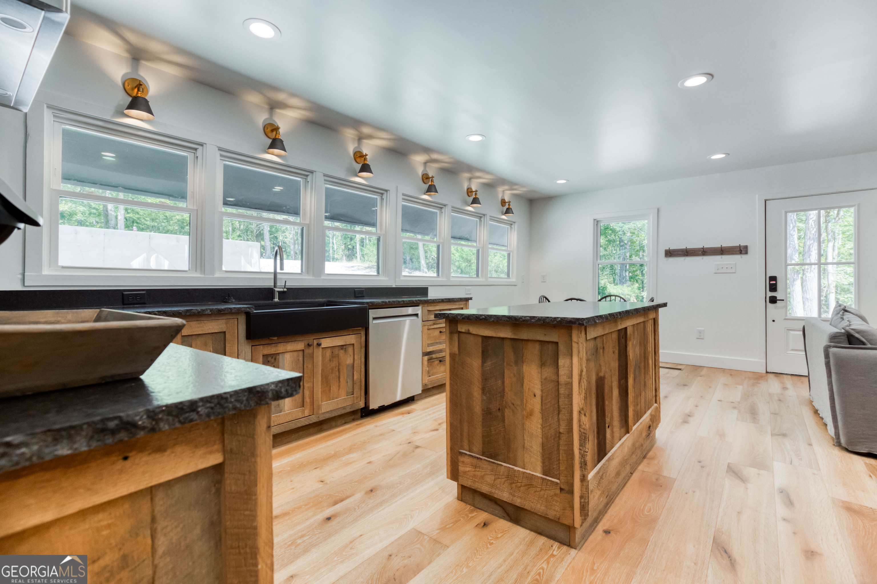 1968 Bobby Brown State Park Road Elberton, GA 30635 - Photo 84 of 97 a kitchen with stainless steel appliances kitchen island granite countertop wooden cabinets a sink and a large window