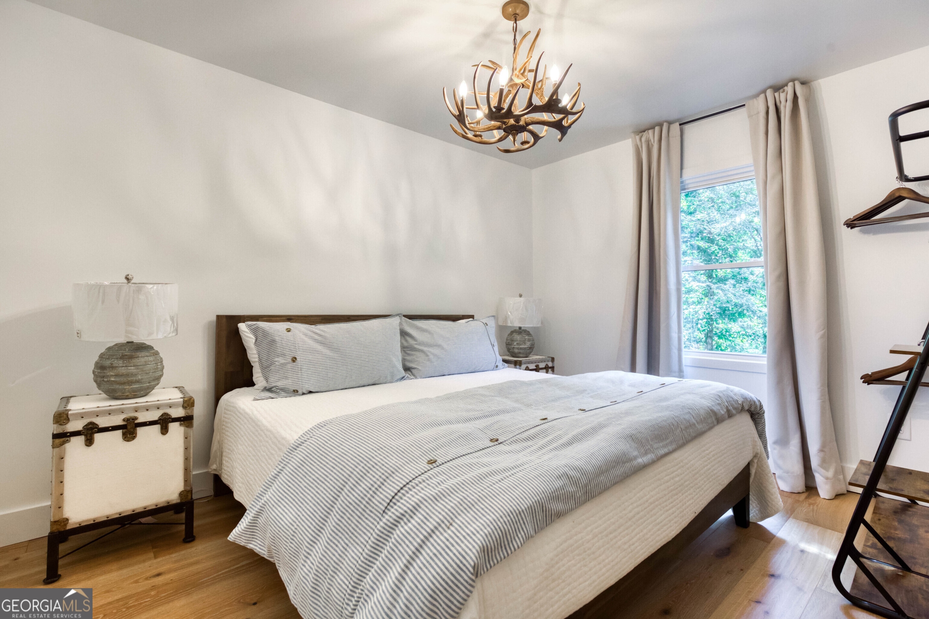 1968 Bobby Brown State Park Road Elberton, GA 30635 - Photo 85 of 97 a bedroom with a bed and a chandelier