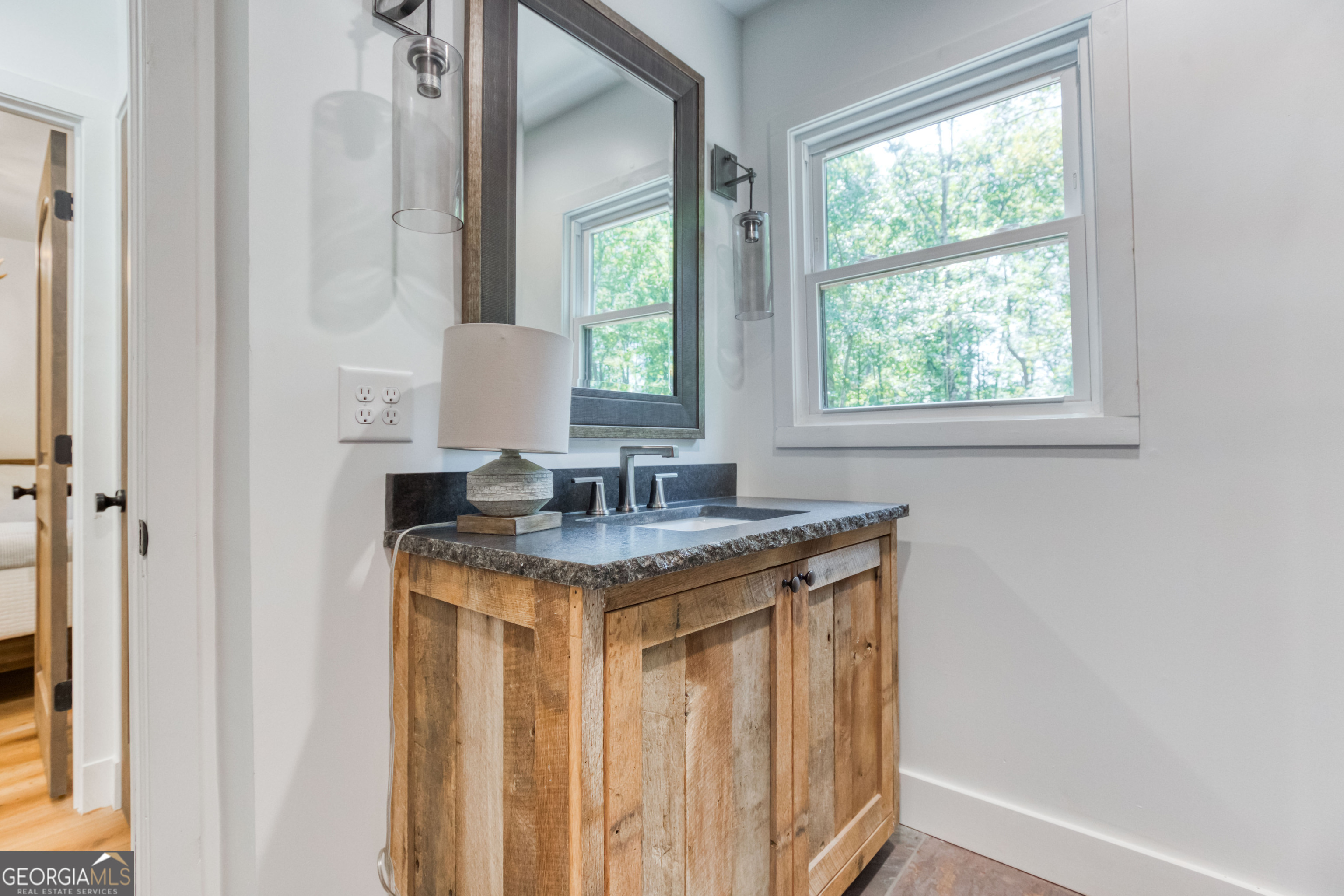 1968 Bobby Brown State Park Road Elberton, GA 30635 - Photo 88 of 97 a bathroom with a granite countertop sink a toilet and a window