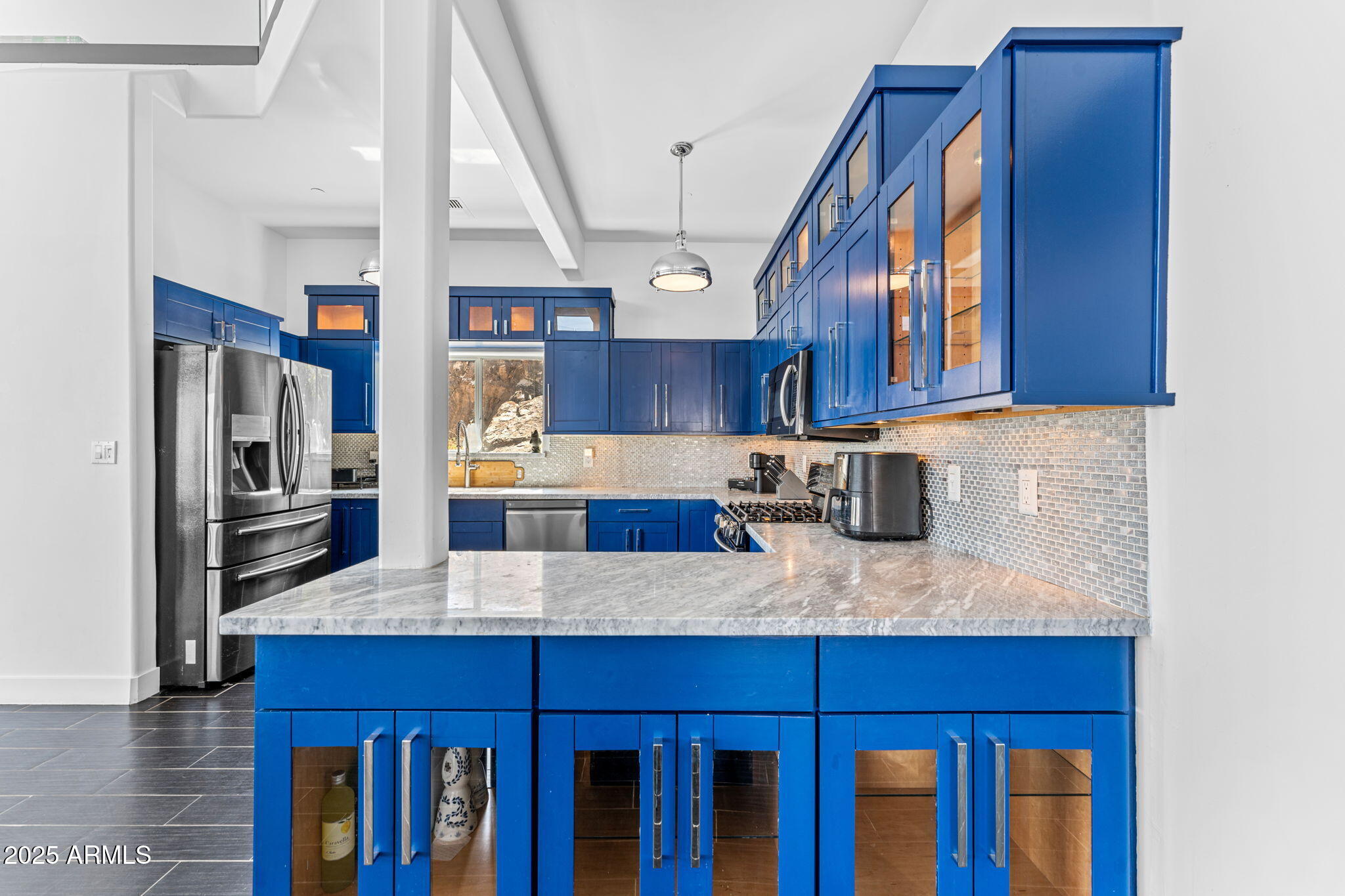 18812 North 22nd Street Phoenix, AZ 85024 - Photo 21 of 71 a kitchen with a refrigerator and wooden cabinets