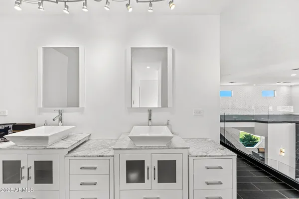 a bathroom with a sink mirror toilet and vanity