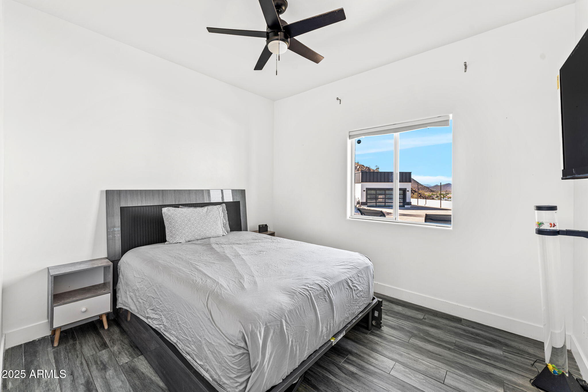 18812 North 22nd Street Phoenix, AZ 85024 - Photo 33 of 71 a bedroom with a bed and wooden floor