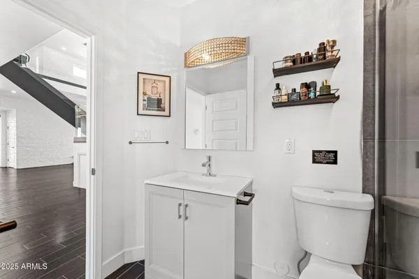 a view of entryway and hall with wooden floor