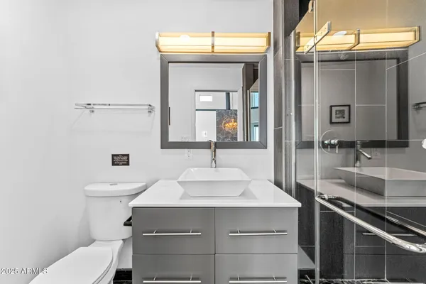 a bathroom with a sink toilet and shower