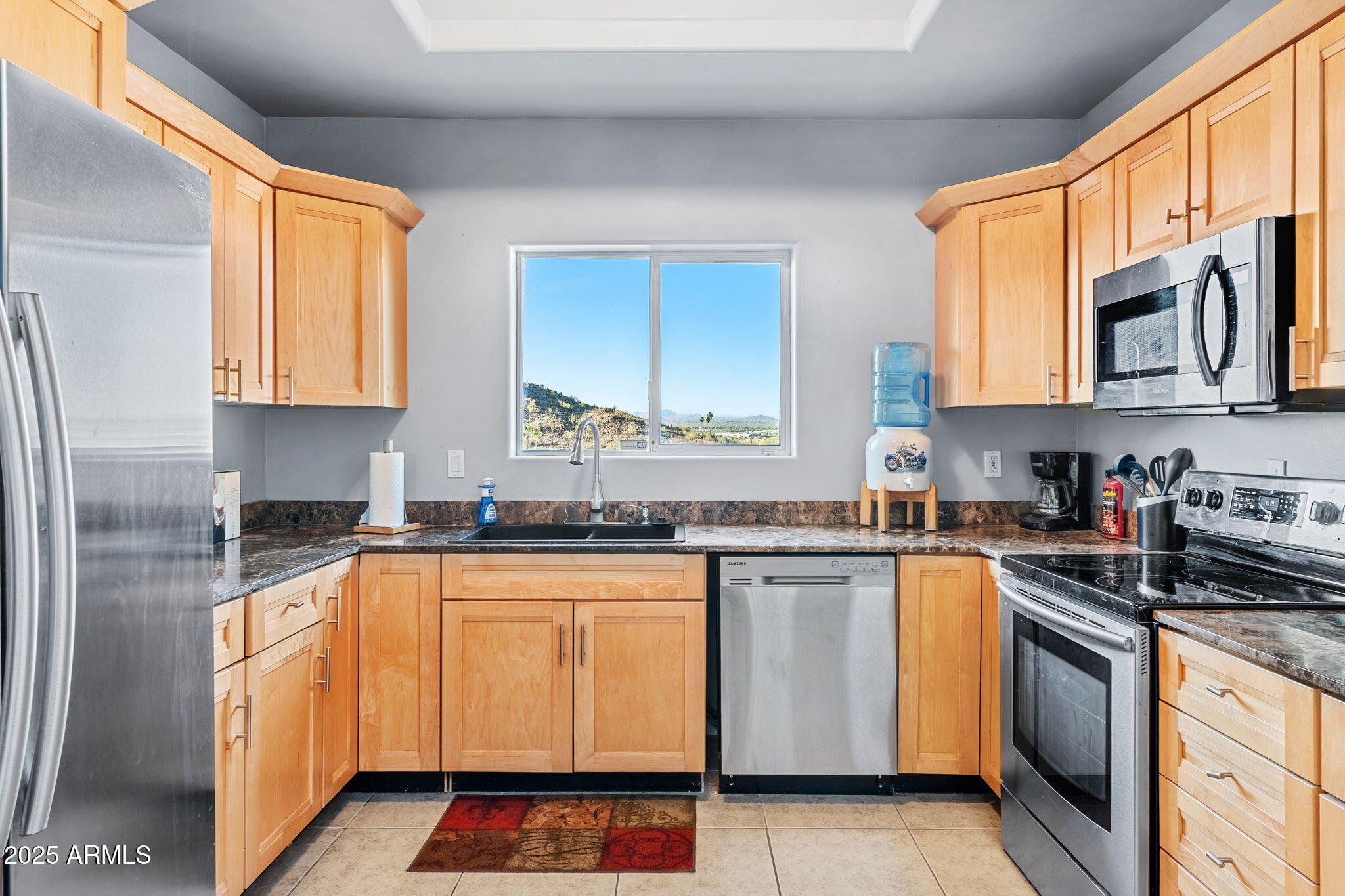 18812 North 22nd Street Phoenix, AZ 85024 - Photo 41 of 71 a kitchen with stainless steel appliances granite countertop a stove sink and cabinets