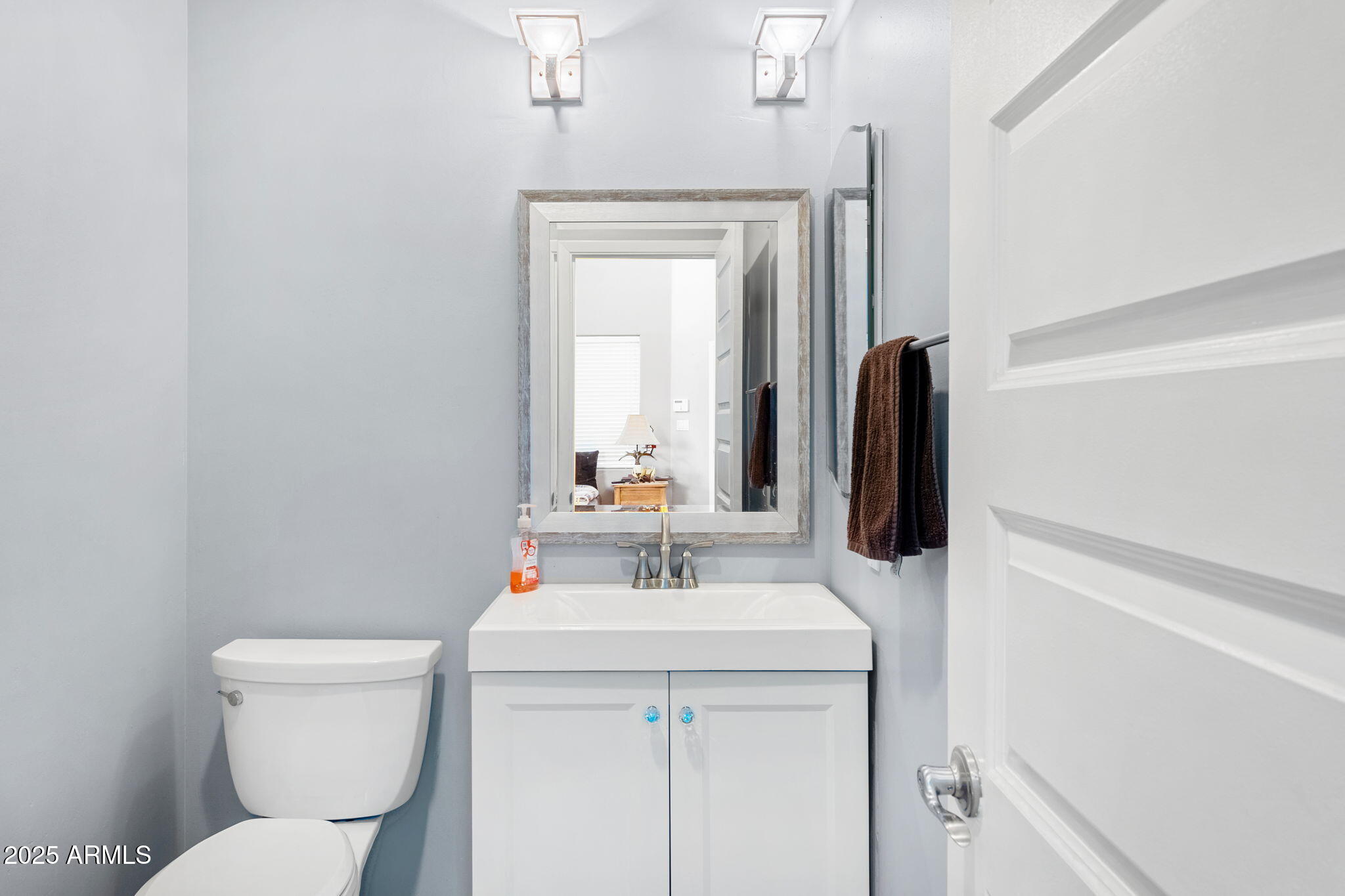 18812 North 22nd Street Phoenix, AZ 85024 - Photo 49 of 71 a bathroom with a toilet sink and mirror