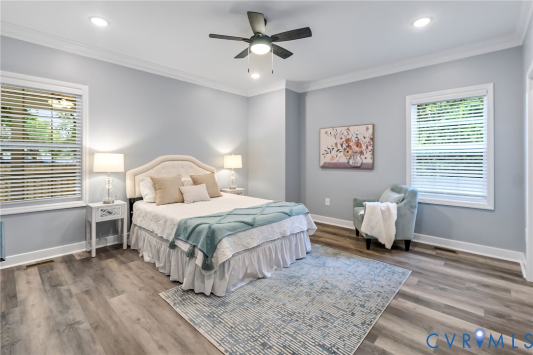710 Harding Street Petersburg, VA 23803 - Photo 14 of 41 1st floor Primary Bedroom with crown molding, wood