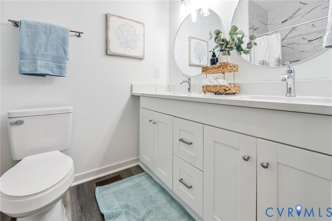 710 Harding Street Petersburg, VA 23803 - Photo 16 of 41 Full bath with double vanity, dark wood-style floo
