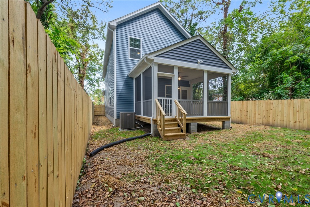 710 Harding Street Petersburg, VA 23803 - Photo 36 of 41 Back of house with a sunroom, a fenced backyard, a