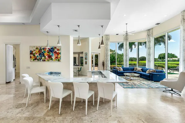 a living room with large windows and furniture