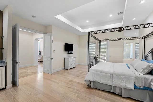 a spacious bathroom with a double vanity sink a large mirror and shower