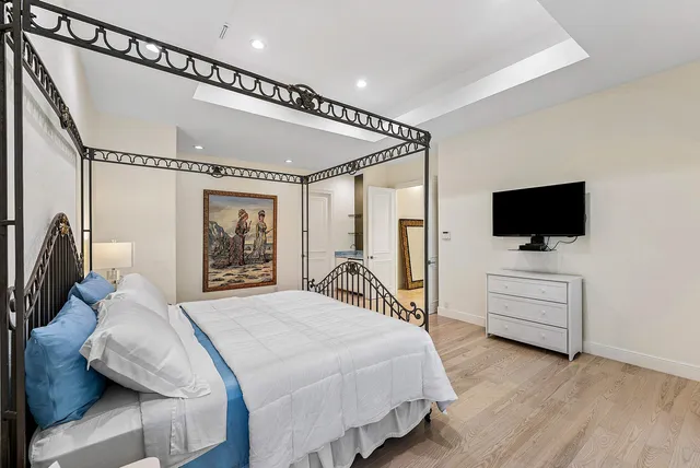 a bathroom with a toilet sink double vanity and mirror