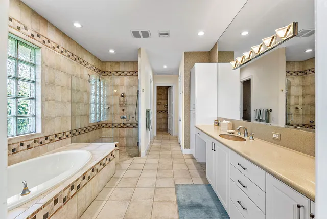 a bathroom with a granite countertop toilet a sink and a large mirror
