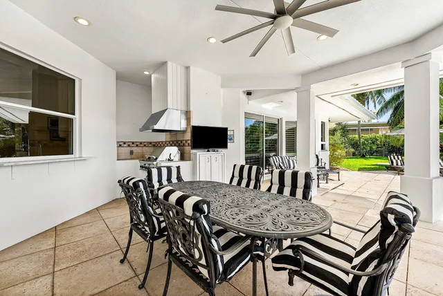 an aerial view of a residential houses with outdoor space and street view