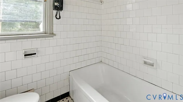a bathroom with a bathtub and toilet