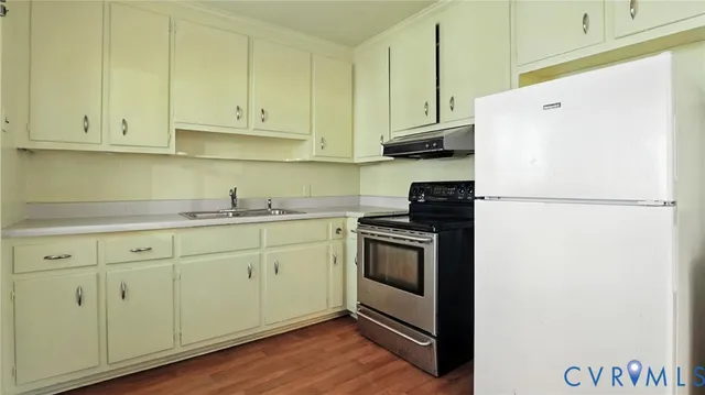 a kitchen with granite countertop white cabinets and white appliances