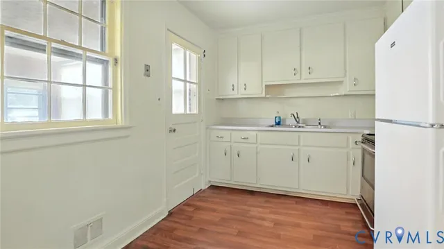 a view of a kitchen with wooden floor