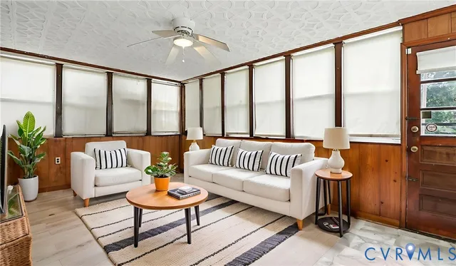 a living room with furniture and a large window with outer view