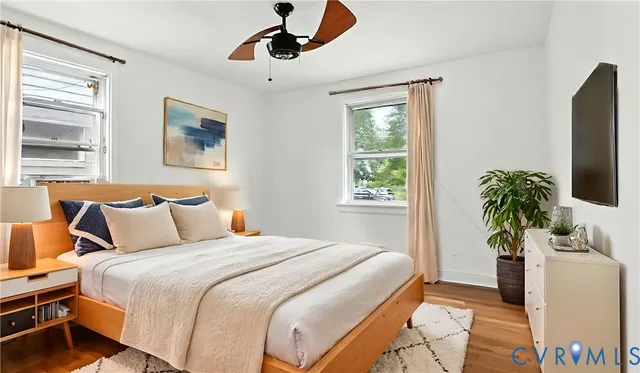 a bedroom with a large bed and a potted plant