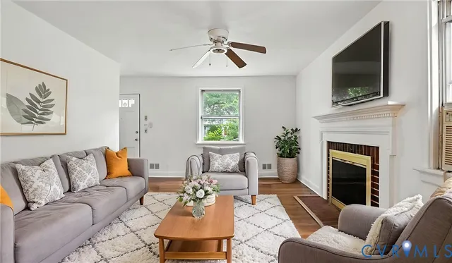 a living room with furniture fireplace and flat screen tv