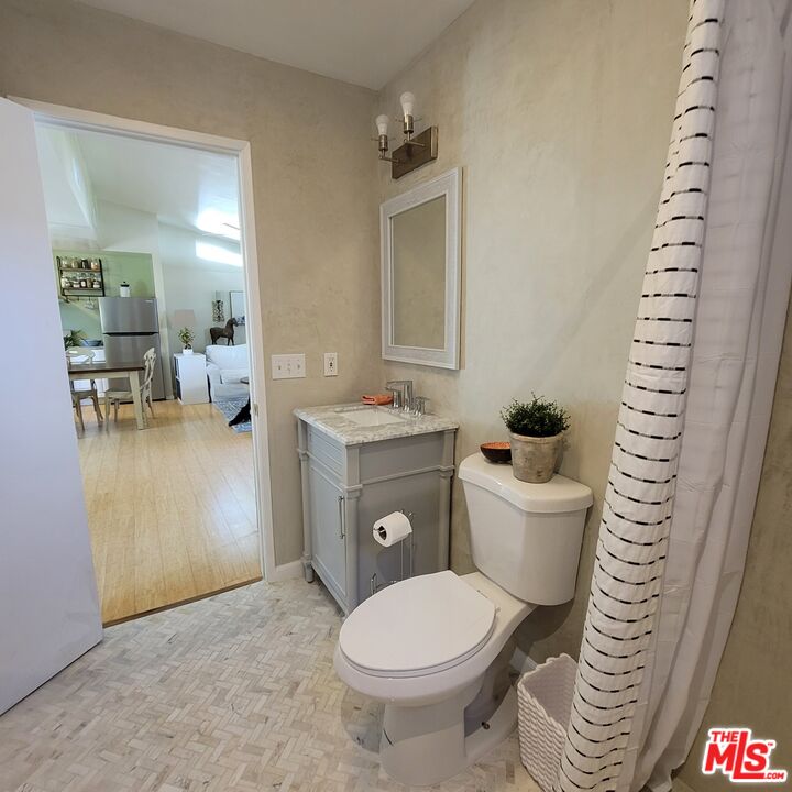 110 Canada Street Ojai, CA 93023 - Photo 16 of 36 a bathroom with a toilet a sink and a mirror