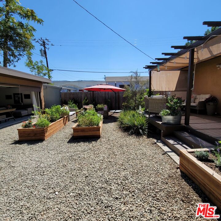110 Canada Street Ojai, CA 93023 - Photo 30 of 36 a backyard of a house with barbeque oven and outdoor seating