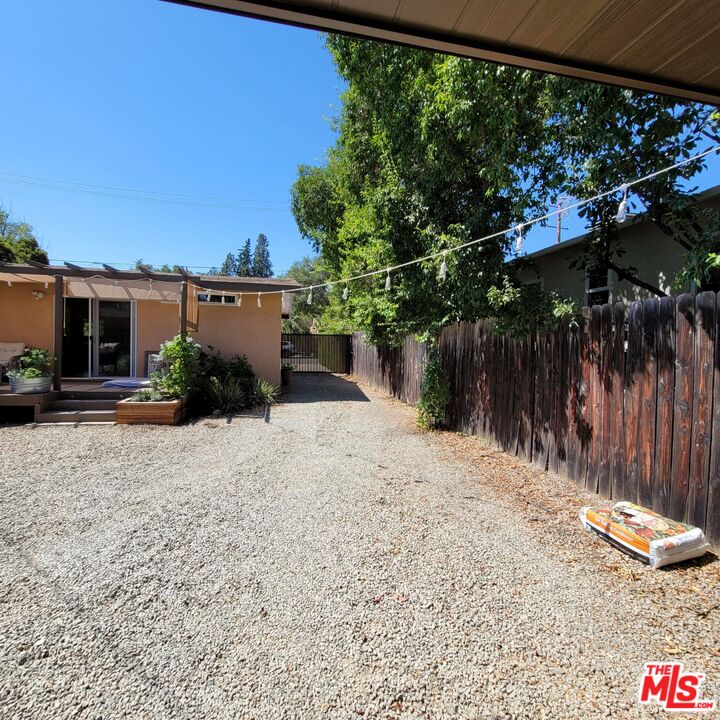 110 Canada Street Ojai, CA 93023 - Photo 31 of 36 a backyard of a house with lots of green space and outdoor seating