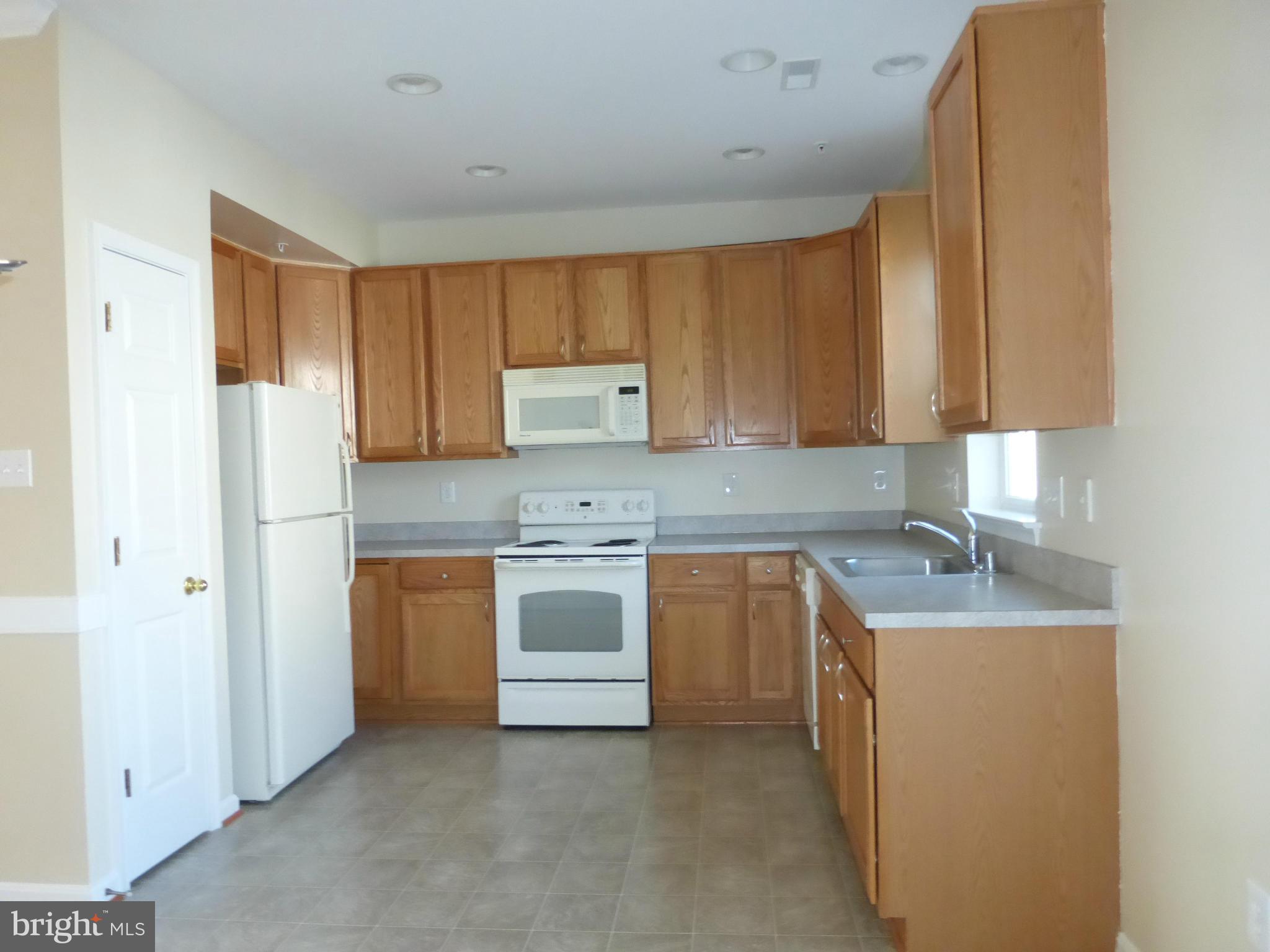 650 Wild Hunt Road Frederick, MD 21703 - Photo 2 of 14 a kitchen with granite countertop a sink stove and refrigerator