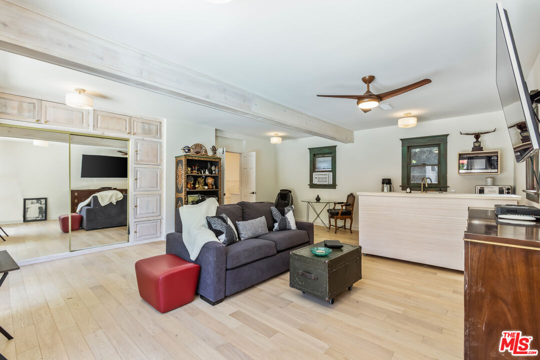 1808 Buckingham Road Los Angeles, CA 90019 - Photo 54 of 75 a living room with furniture a fireplace and a flat screen tv