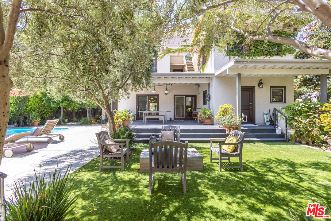 1808 Buckingham Road Los Angeles, CA 90019 - Photo 63 of 75 a view of a house with sitting area and swimming pool