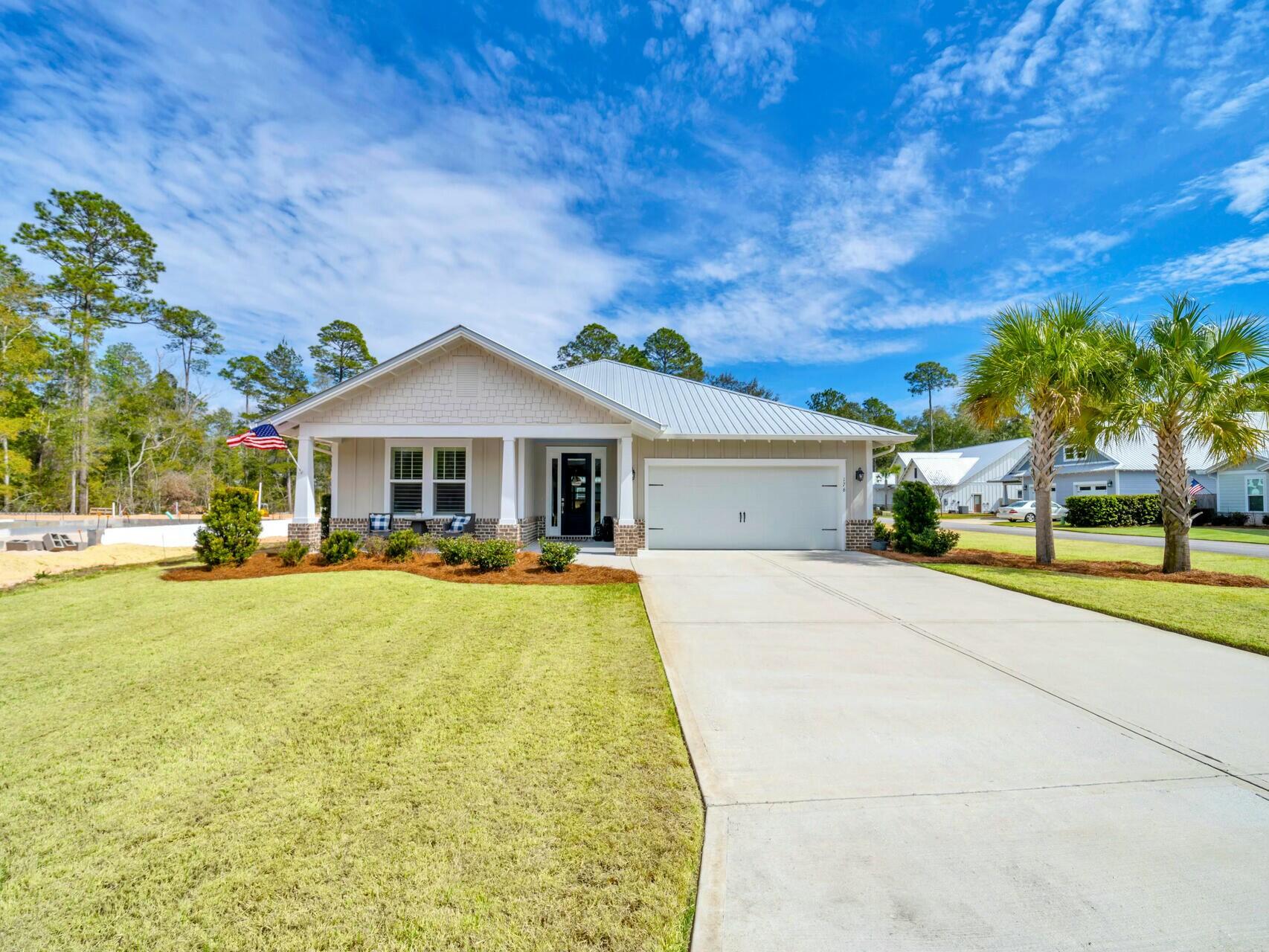 176 Hibernate Way Freeport, FL 32439 - Photo 1 of 66 a front view of house with yard and swimming pool