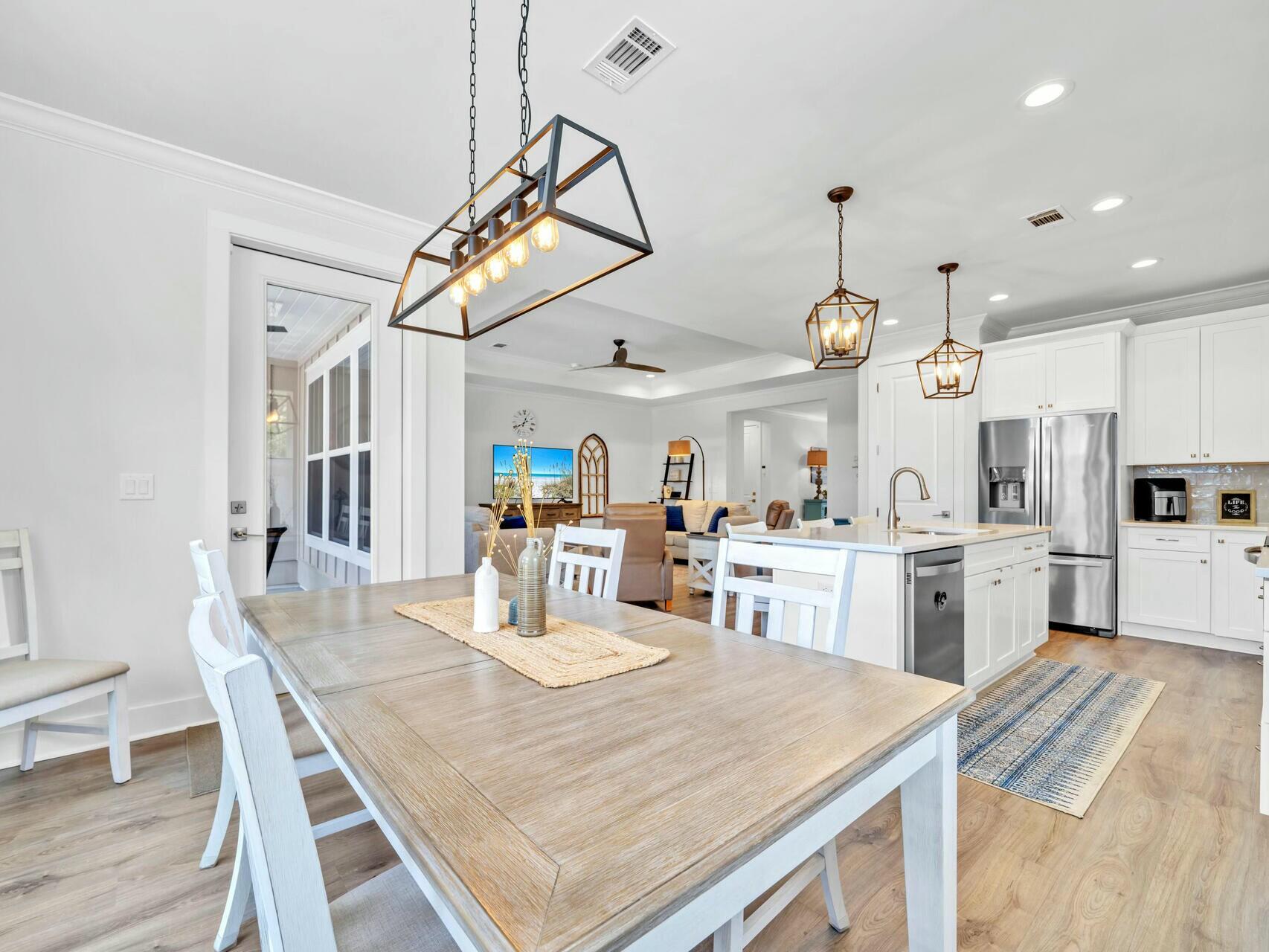 176 Hibernate Way Freeport, FL 32439 - Photo 18 of 66 a view of a dining room and livingroom with furniture wooden floor kitchen view