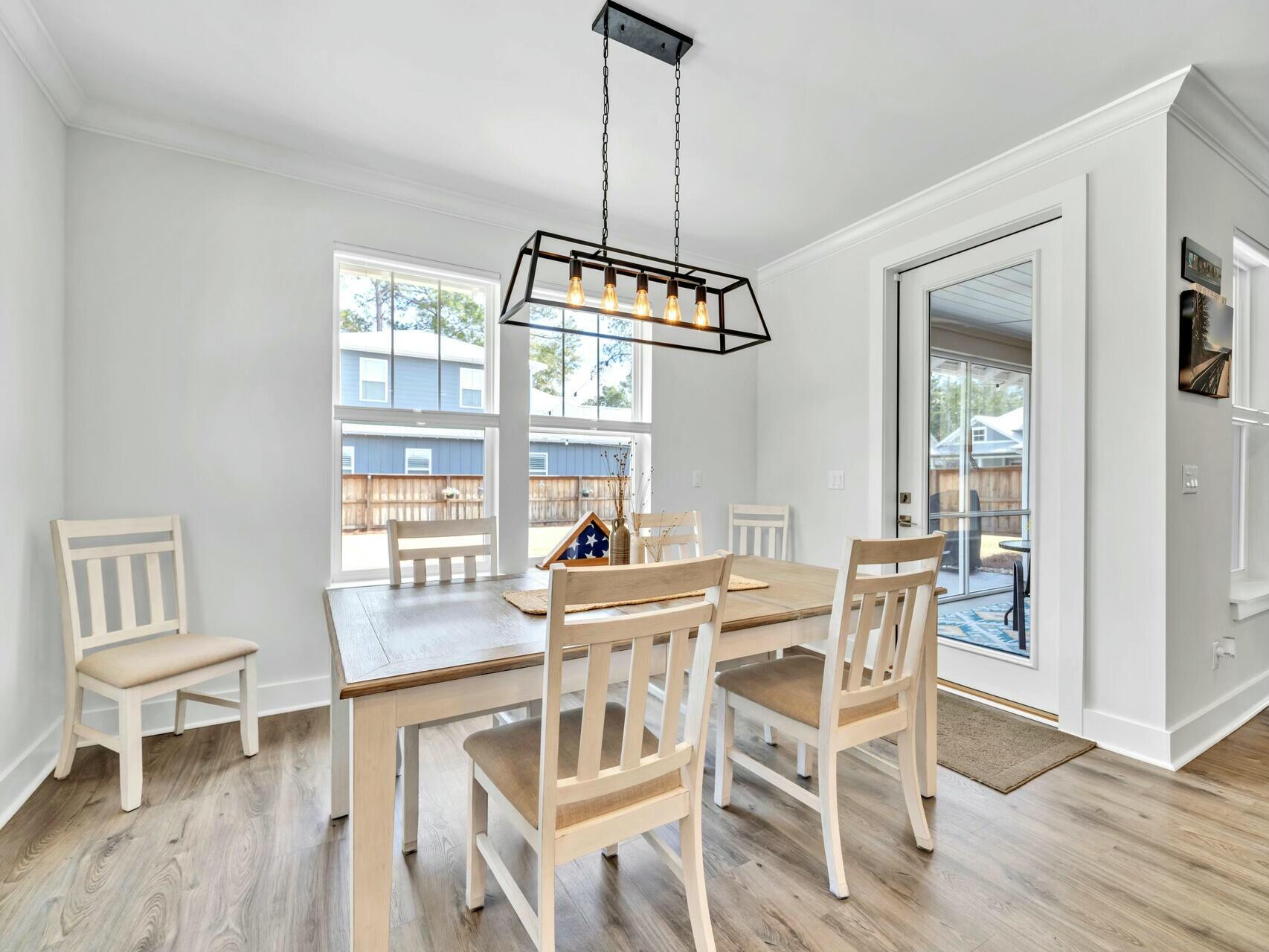 176 Hibernate Way Freeport, FL 32439 - Photo 21 of 66 a view of a dining room with furniture window and wooden floor