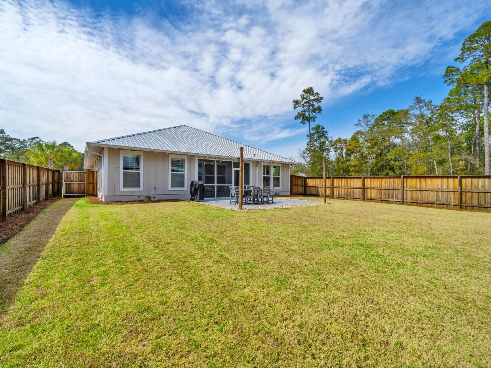 176 Hibernate Way Freeport, FL 32439 - Photo 29 of 66 a front view of a house with a garden