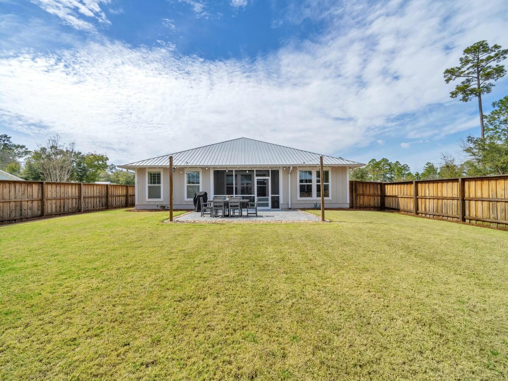176 Hibernate Way Freeport, FL 32439 - Photo 30 of 66 a front view of a house with a garden