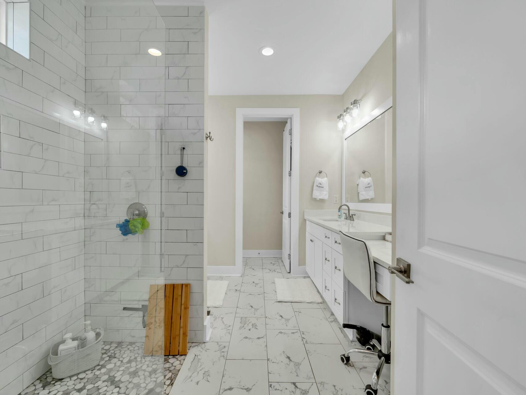 176 Hibernate Way Freeport, FL 32439 - Photo 34 of 66 a spacious bathroom with a granite countertop sink a mirror and shower