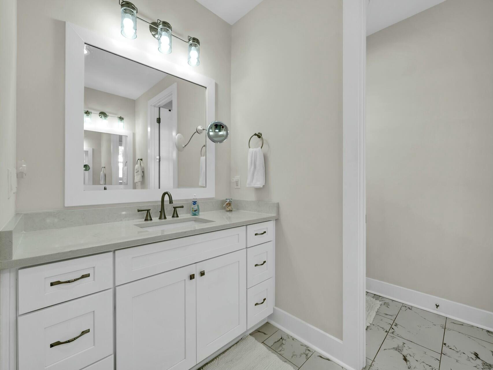 176 Hibernate Way Freeport, FL 32439 - Photo 36 of 66 a bathroom with a granite countertop sink mirror and vanity