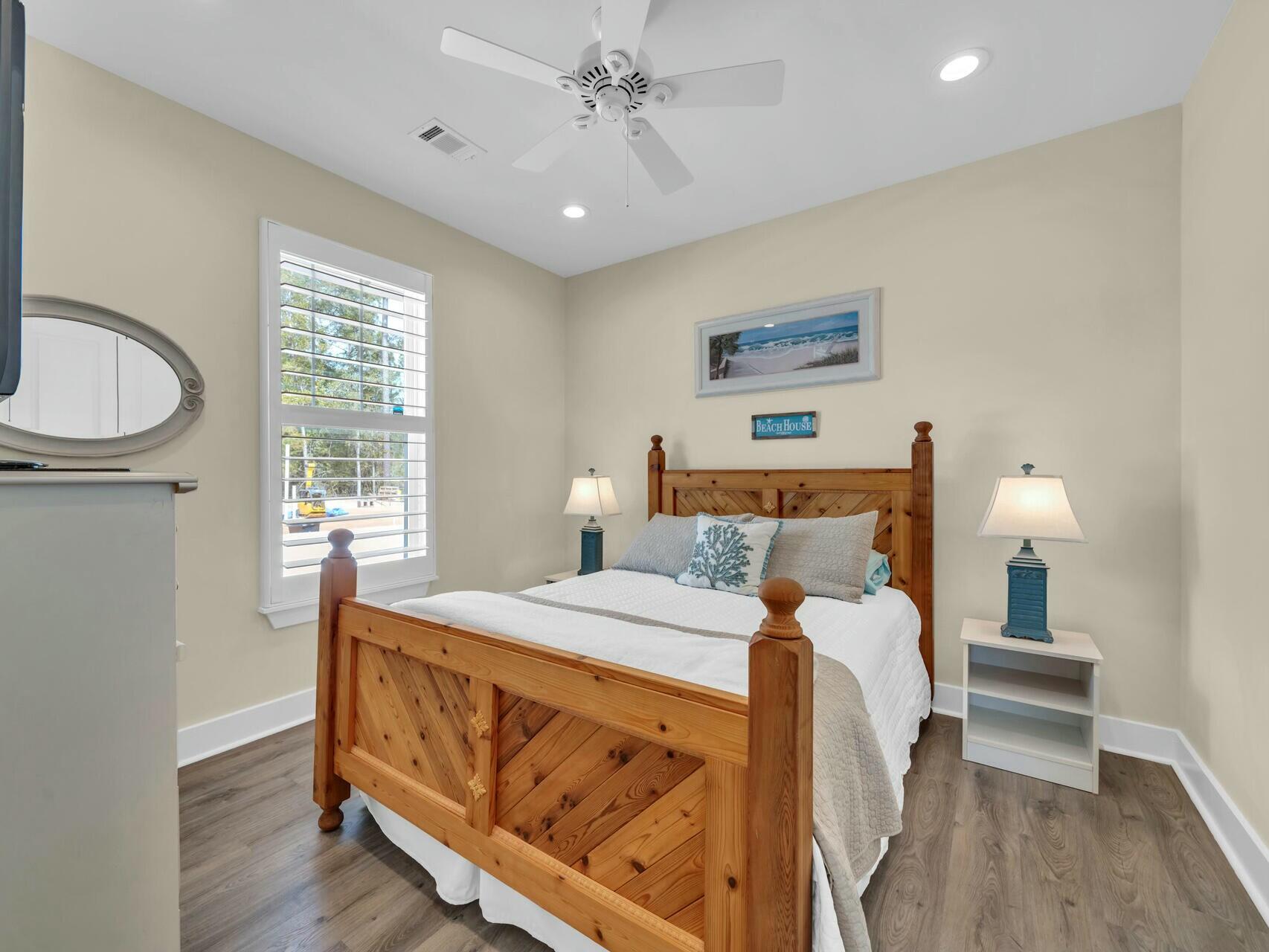 176 Hibernate Way Freeport, FL 32439 - Photo 41 of 66 a bedroom with a bed and wooden floor