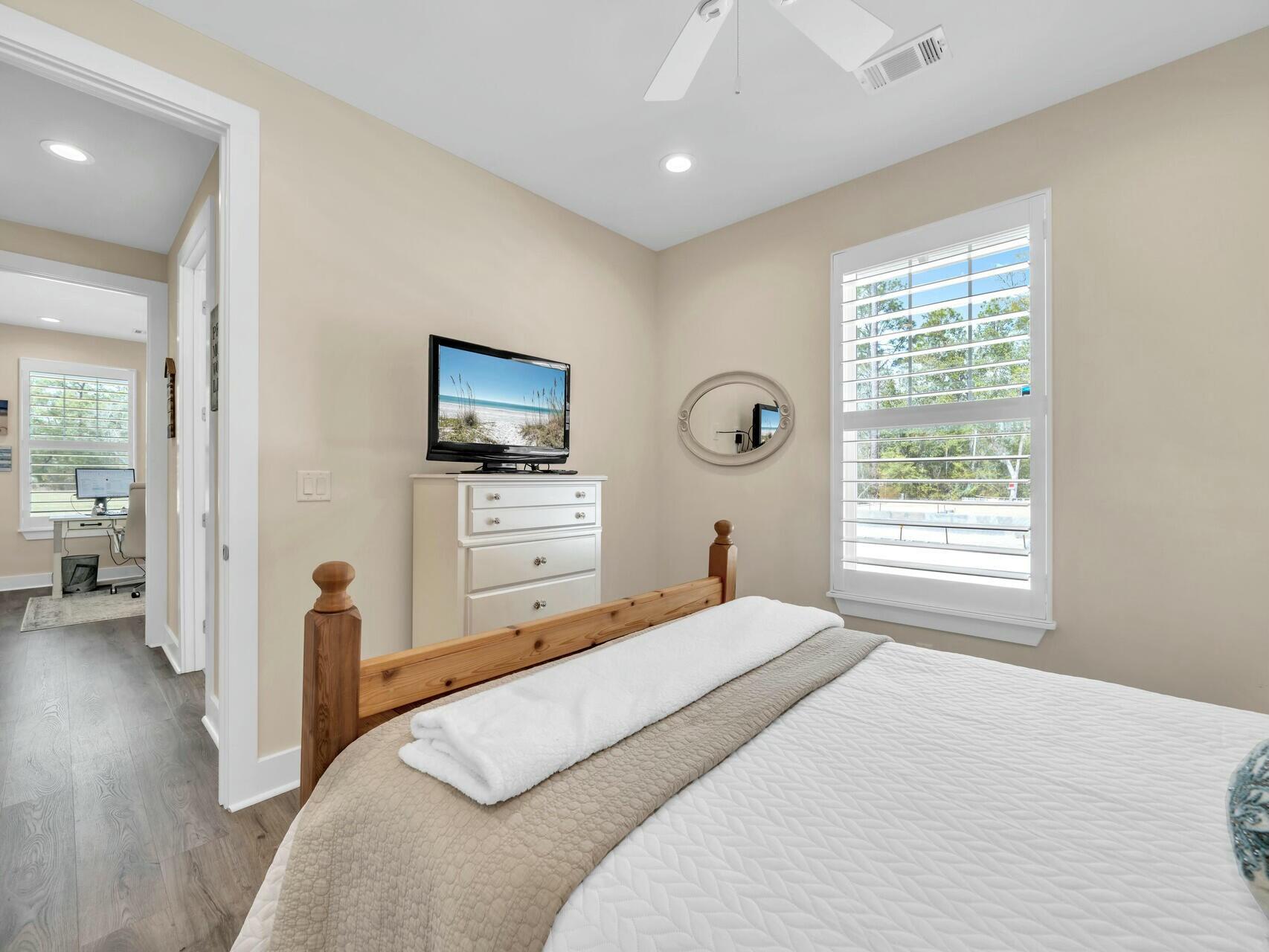 176 Hibernate Way Freeport, FL 32439 - Photo 42 of 66 a bedroom with a bed and a flat screen tv