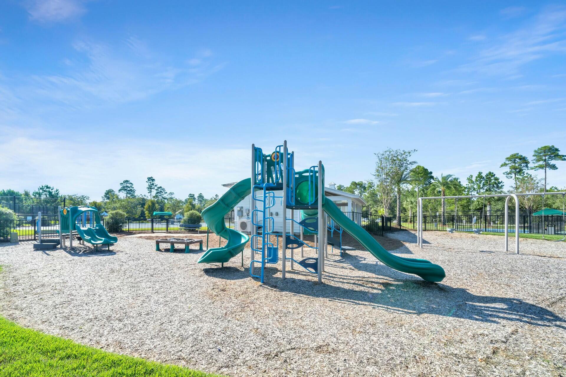 176 Hibernate Way Freeport, FL 32439 - Photo 52 of 66 a view of a park with swings and slides
