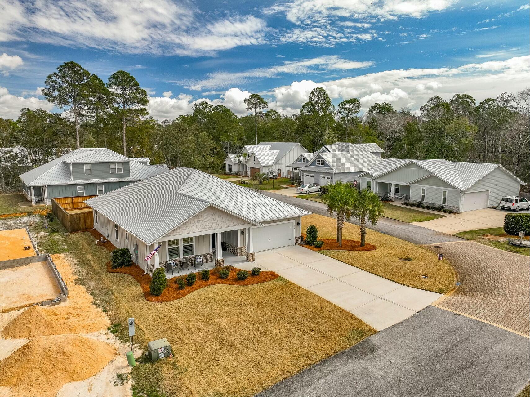 176 Hibernate Way Freeport, FL 32439 - Photo 64 of 66 a aerial view of a house with swimming pool and sitting area