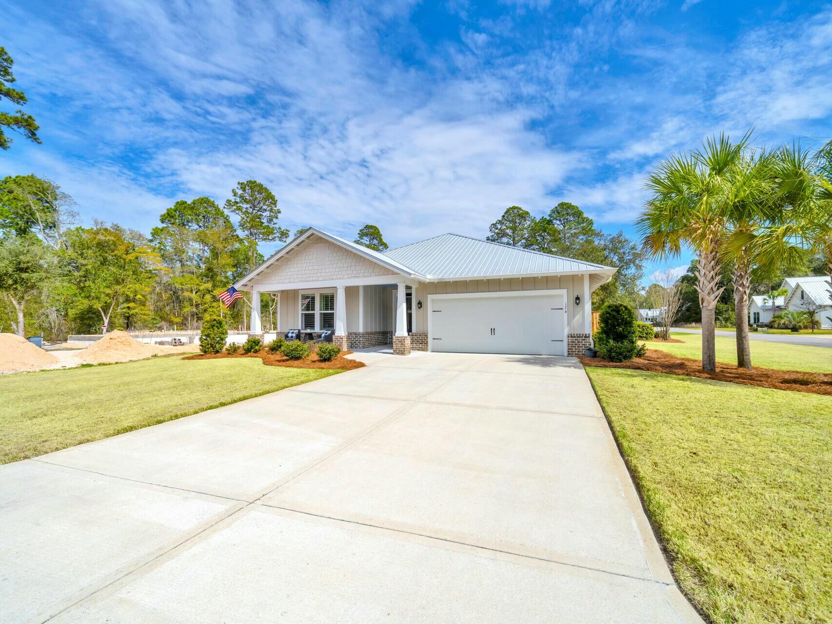 176 Hibernate Way Freeport, FL 32439 - Photo 65 of 66 a front view of a house with garden