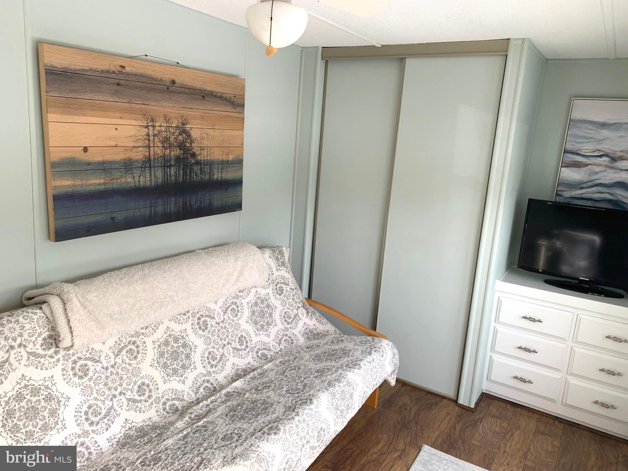 21229 M Street Rehoboth Beach, DE 19971 - Photo 15 of 23 a bedroom with a bed and a television in it