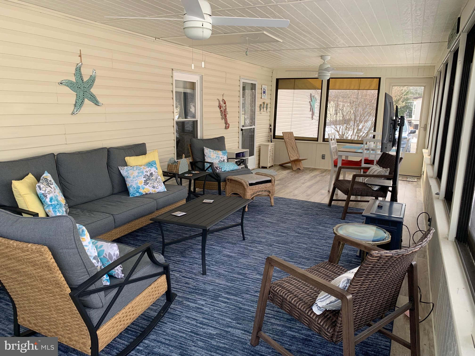 21229 M Street Rehoboth Beach, DE 19971 - Photo 3 of 23 a living room with furniture and a large window