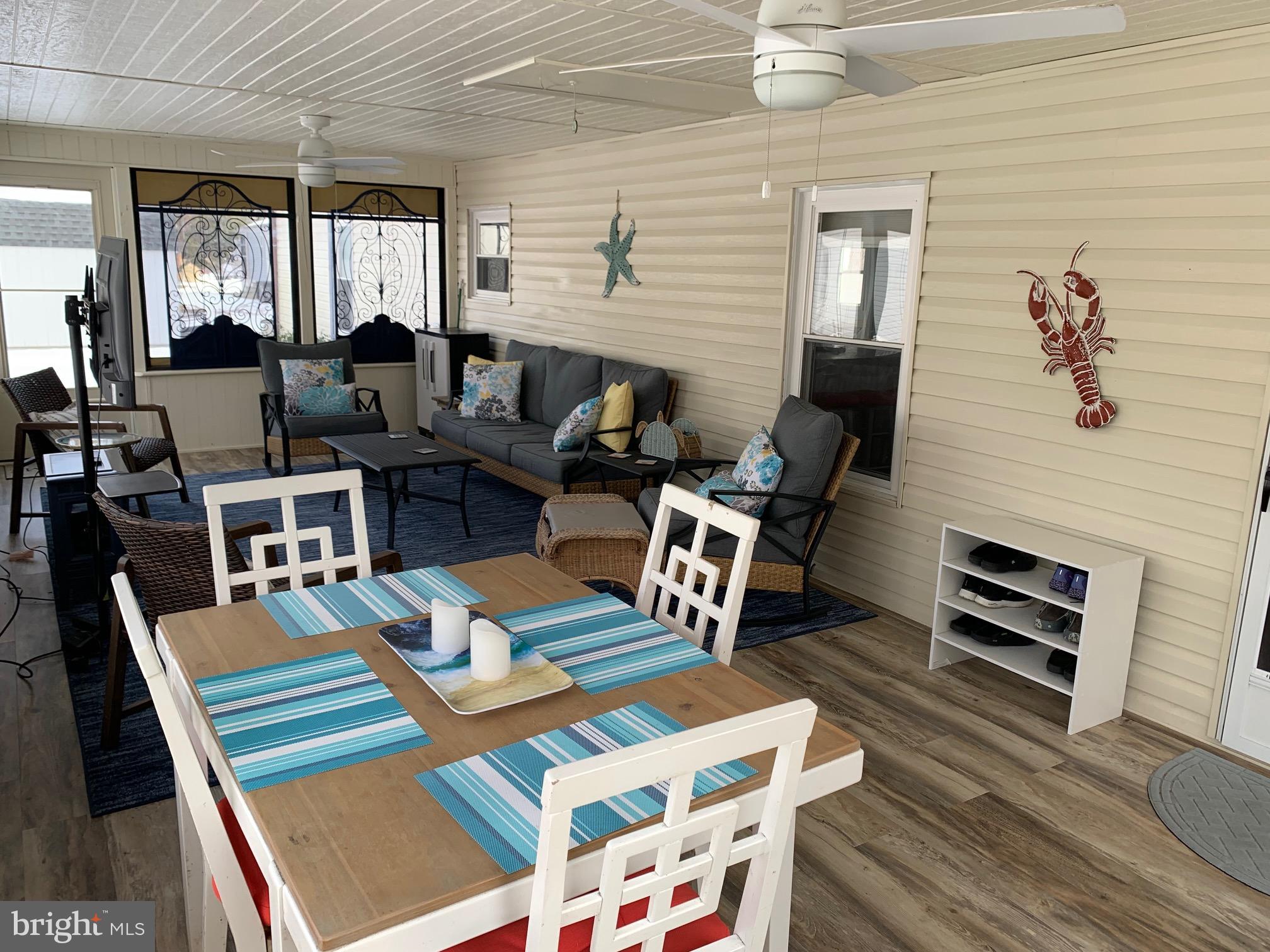 21229 M Street Rehoboth Beach, DE 19971 - Photo 4 of 23 a living room with furniture a fireplace and large window