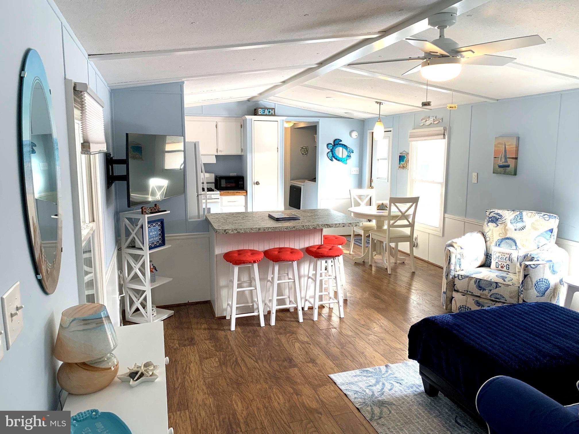 21229 M Street Rehoboth Beach, DE 19971 - Photo 6 of 23 a living room with furniture and wooden floor