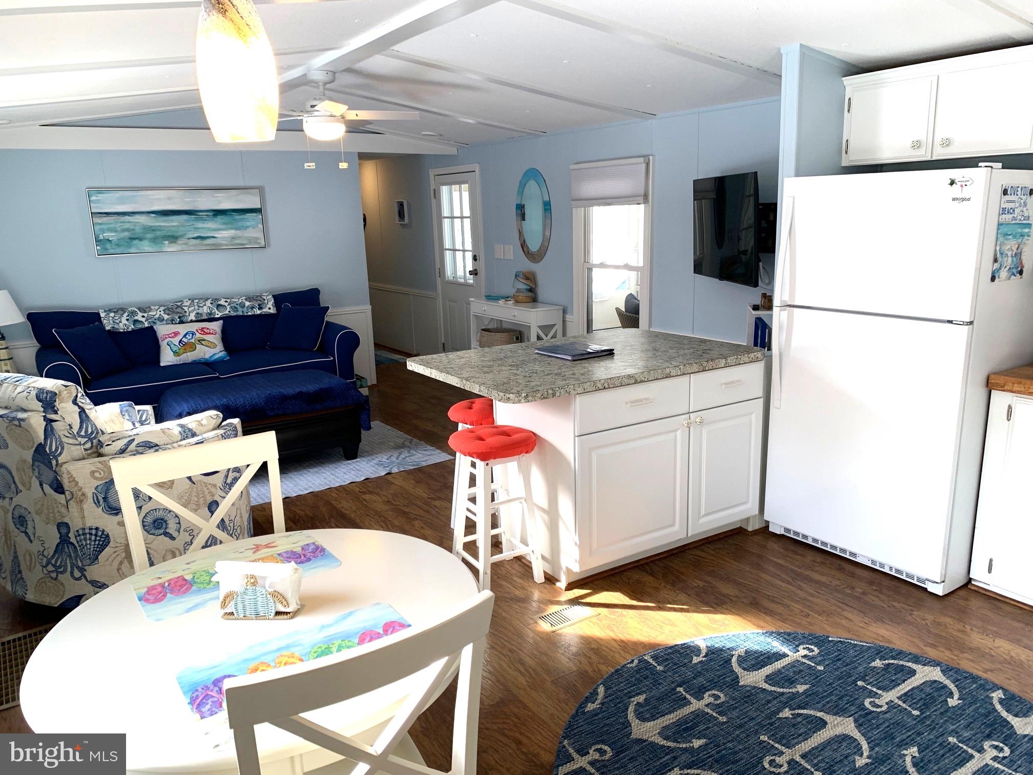 21229 M Street Rehoboth Beach, DE 19971 - Photo 7 of 23 a very nice looking dining room with a dining table and a refrigerator